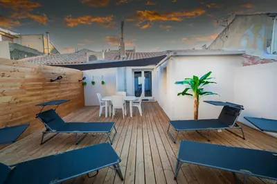 a balcony with blue chairs and a table on a building at Superbe appartement à 2 pas des Halles, Climatisé, terrasse, garage in Narbonne