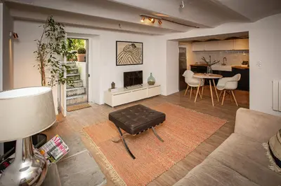 a living room with a couch and a table at Beautiful converted one bedroom apartment in Carcassonne