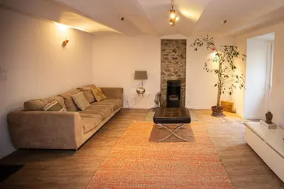 a living room with a couch and a table at Beautiful converted one bedroom apartment in Carcassonne