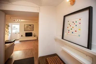 a living room with a picture on the wall at Beautiful converted one bedroom apartment in Carcassonne