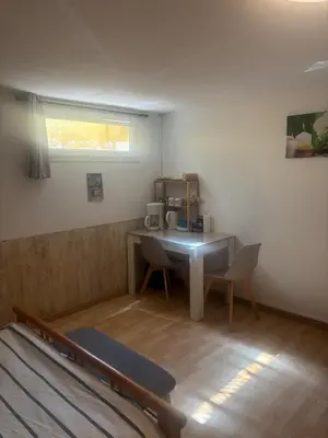 a small room with a table and a coffee machine at chez Angélique in Marcorignan