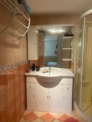 a bathroom with a sink and a mirror at chez Angélique in Marcorignan