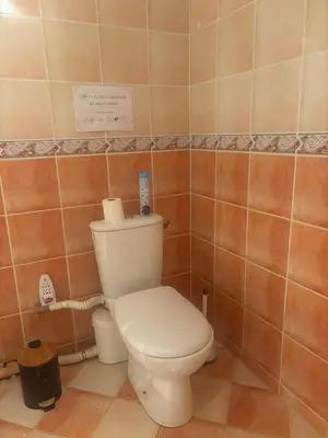 a bathroom with a toilet and a sign on the wall at chez Angélique in Marcorignan