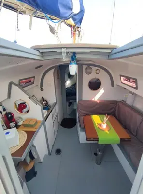 an interior view of a boat with a bed and a table at St Helene in Gruissan