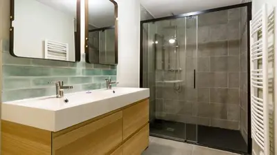 a bathroom with a sink and a shower at Belle et grande maison de village au bord de l'eau in Peyriac-de-Mer