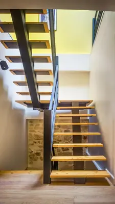 a staircase with wooden risers in a building at Belle et grande maison de village au bord de l'eau in Peyriac-de-Mer