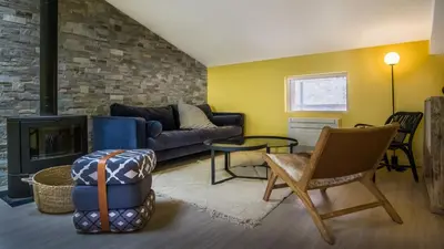 a living room with a couch and a fireplace at Belle et grande maison de village au bord de l'eau in Peyriac-de-Mer