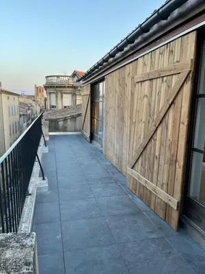 a balcony with a wooden fence and a wooden door at Rooftop Standing Place Carnot in Carcassonne