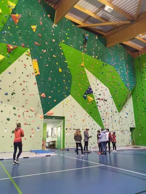 a group of people standing in front of a climbing wall at Belle maison proche de la ville et du lac in Belcaire