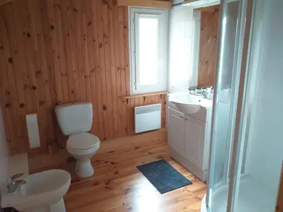 a bathroom with a toilet and a sink and a shower at Belle maison proche de la ville et du lac in Belcaire