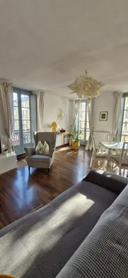 a living room with a couch and a table at les jardins de l'archevêché in Narbonne
