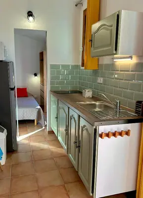 a kitchen with a sink and a counter top at village vacances du camboussel in Brassac