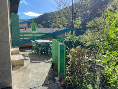 a group of picnic tables and a playground at village vacances du camboussel in Brassac