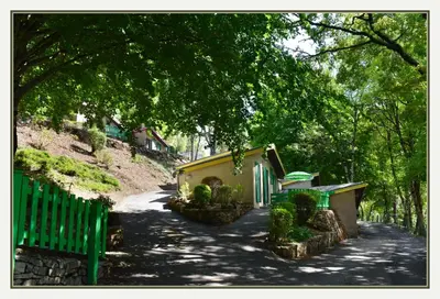 a bridge over a river in a town at village vacances du camboussel in Brassac