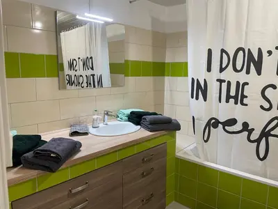 a bathroom with a sink and a mirror and a tub at L’oustal in Vaudreuille