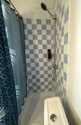 a small bathroom with a shower and a sink at Le Lamourguier in Narbonne