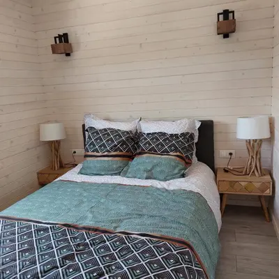 a bedroom with a bed with two lamps on two tables at Lodge d'Œnotourisme avec vue imprenable ! in Vingrau