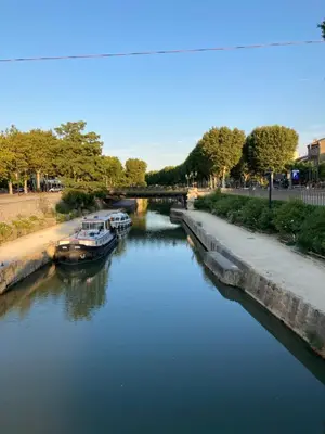 a group of boats docked in a river at COLORS by Reine du Sud, proche des Grands Buffets in Narbonne