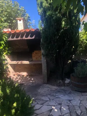 a house with a tile roof and a stone patio at COLORS by Reine du Sud, proche des Grands Buffets in Narbonne