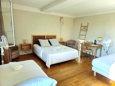 a bedroom with two beds and a desk and a ladder at Chambre d'hôtes Les Berges de l'Aude - B&B - Proche Canal du midi & Carcassonne in Puicheric