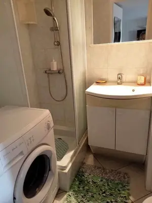 a bathroom with a washing machine and a sink at résidence les amandines in Gruissan