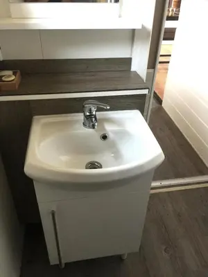 a white sink in a bathroom with a mirror at Chalet en bois 