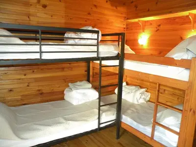 a room with three bunk beds in a cabin at GRANDE MAISON FAMILIALE in Escouloubre
