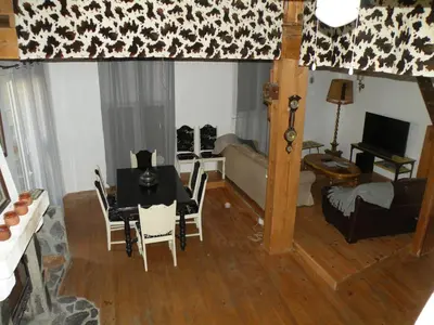 a living room with a table and a couch at GRANDE MAISON FAMILIALE in Escouloubre