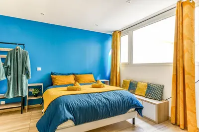 a blue bedroom with a bed and a window at EDEN SUITE - Jacuzzi - Parking - Clim by Narbana in Narbonne