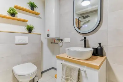 a bathroom with a white sink and a mirror at EDEN SUITE - Jacuzzi - Parking - Clim by Narbana in Narbonne
