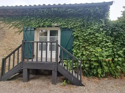 a house with a green door and a staircase at La Marceline 1 - Appart entre mer et canal du midi en pays Cathare in Saint-Marcel