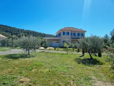 a house in a field with olive trees at Clos des Oliviers in Oupia