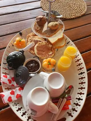 a plate of breakfast food with coffee and toast at Les pieds en éventail in Lignairolles