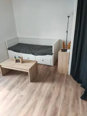 a bedroom with a bed and a coffee table at Le quai in Port-la-Nouvelle