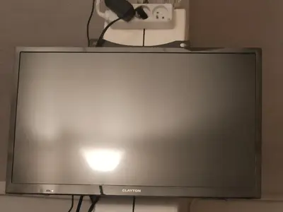 a flat screen tv sitting on top of a table at Le quai in Port-la-Nouvelle