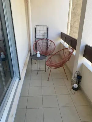 a room with a desk and a brick wall at Charmant studio, cœur de ville in Narbonne