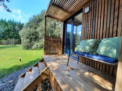 a porch of a house with a bench on it at Le lodge des chênes in Brousses-et-Villaret