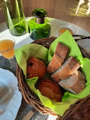 a basket of bread and other foods on a table at Le lodge des chênes in Brousses-et-Villaret