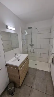 a bathroom with a sink and a shower at Résidence du Portail d'Avail in Sigean