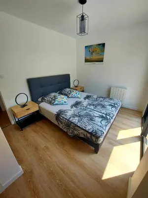 a bedroom with a bed and a wooden floor at La Belle Vie en Alaric in Douzens