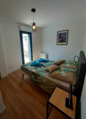 a bedroom with a bed and a table in it at La Belle Vie en Alaric in Douzens