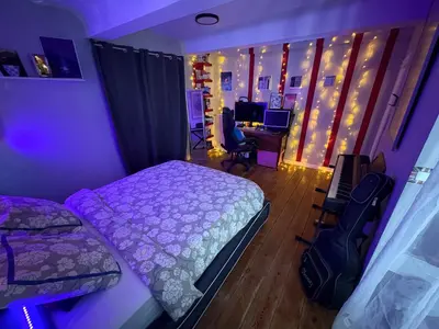 a bedroom with a bed and a desk with a computer at Symphony du Vivant in Lautrec
