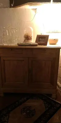 a wooden cabinet with a book on top of it at Symphony du Vivant in Lautrec