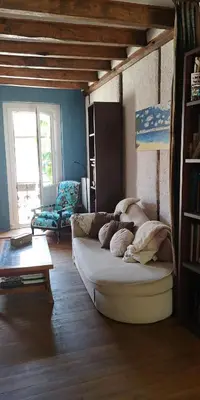 a living room with a couch and a table at Symphony du Vivant in Lautrec
