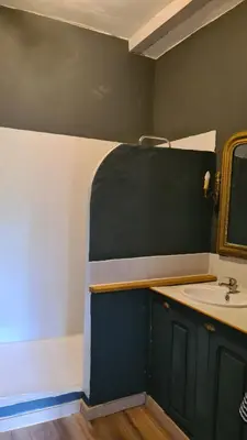 a bathroom with a sink and a mirror at Gîte du caveau in Marcorignan