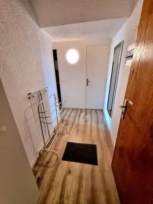 an empty room with a hallway with a door at Bellyenmer Gruissan in Gruissan