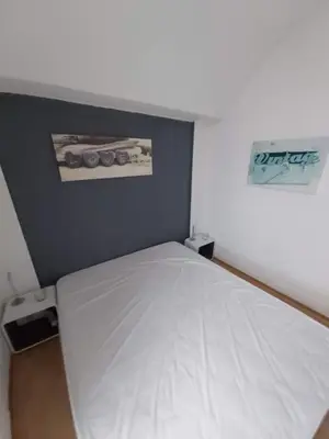 a small bedroom with a white bed in it at Bellyenmer Gruissan in Gruissan