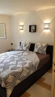 a bedroom with a bed with two pillows on it at Sur les pas de Pierre Paul Riquet in Montferrand