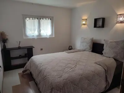 a bedroom with a large bed and a window at Sur les pas de Pierre Paul Riquet in Montferrand