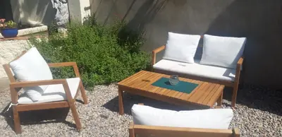 a patio with two chairs and a table and a table and chairs at Maison Occitane in Saint-Nazaire-dʼAude